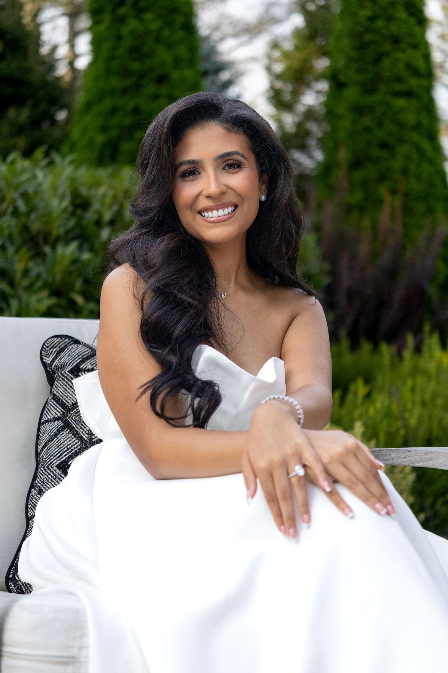 Bride-to-be smiling in a white dress at her backyard bridal shower in New Jersey