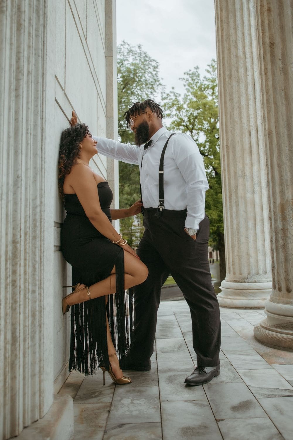 Couple between the limestone columns of Clio Hall, Princeton University