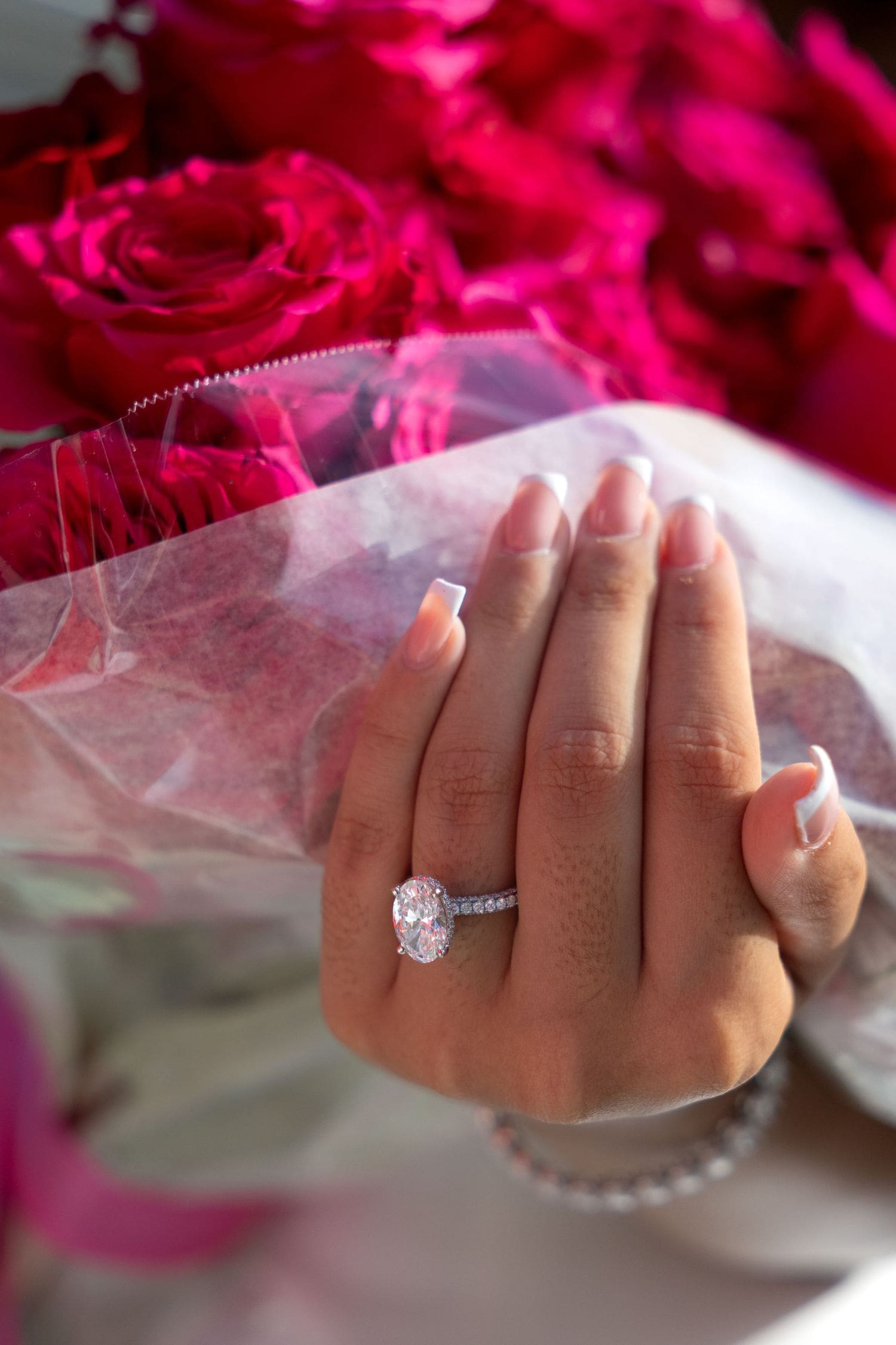 Engagement ring close-up with red roses at a New Jersey bridal shower