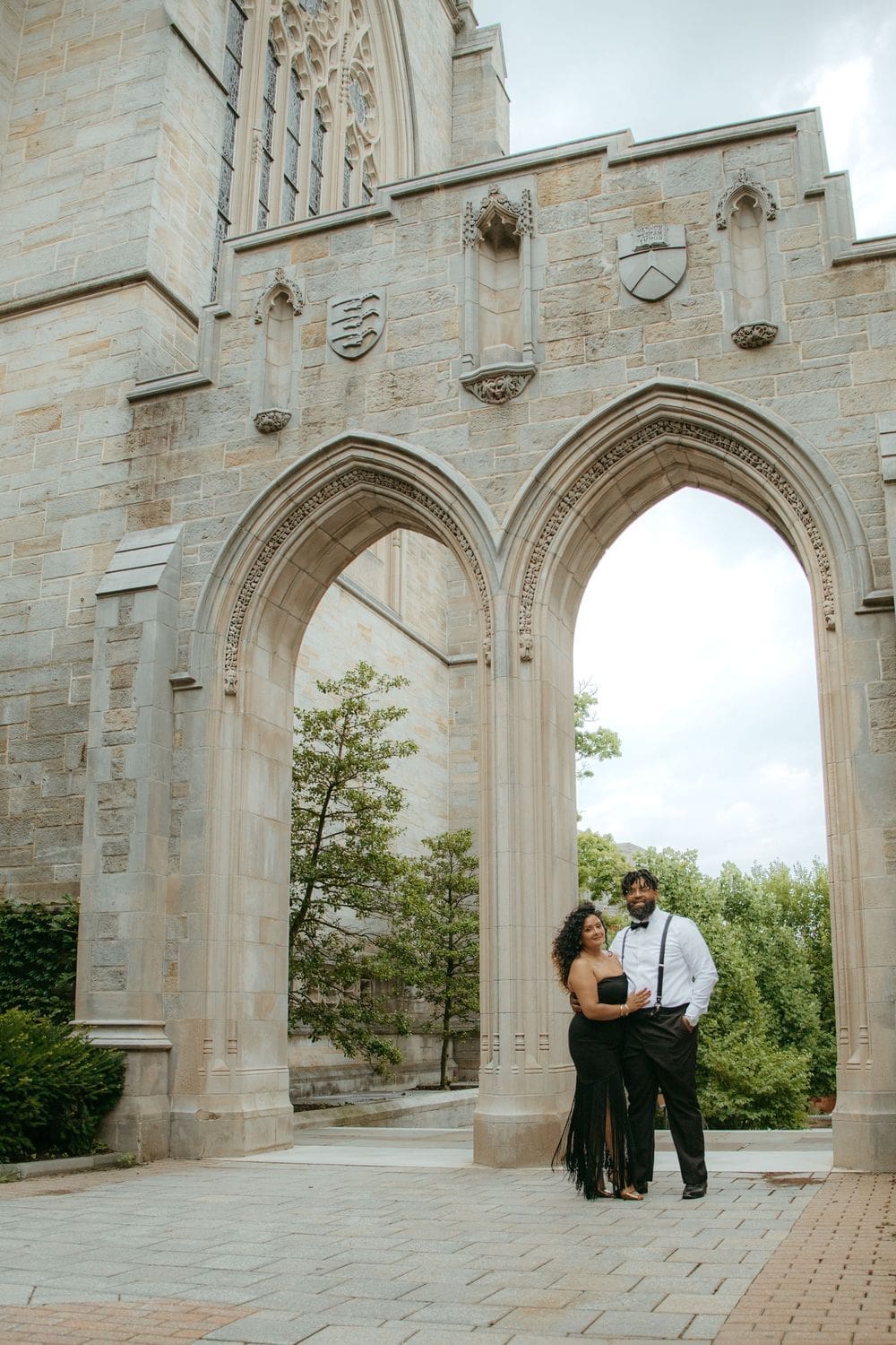 Couple under the Gothic Rothschild Arch at Princeton University